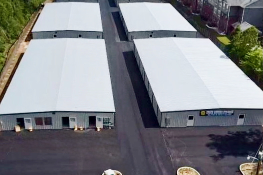 Secure climate-controlled storage facility at Space Savers Storage in Mobile, AL, with security fencing and ground floor access for easy loading.